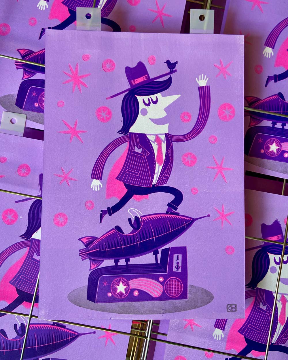 man balancing on vintage rocket ride linocut print with bird on hat