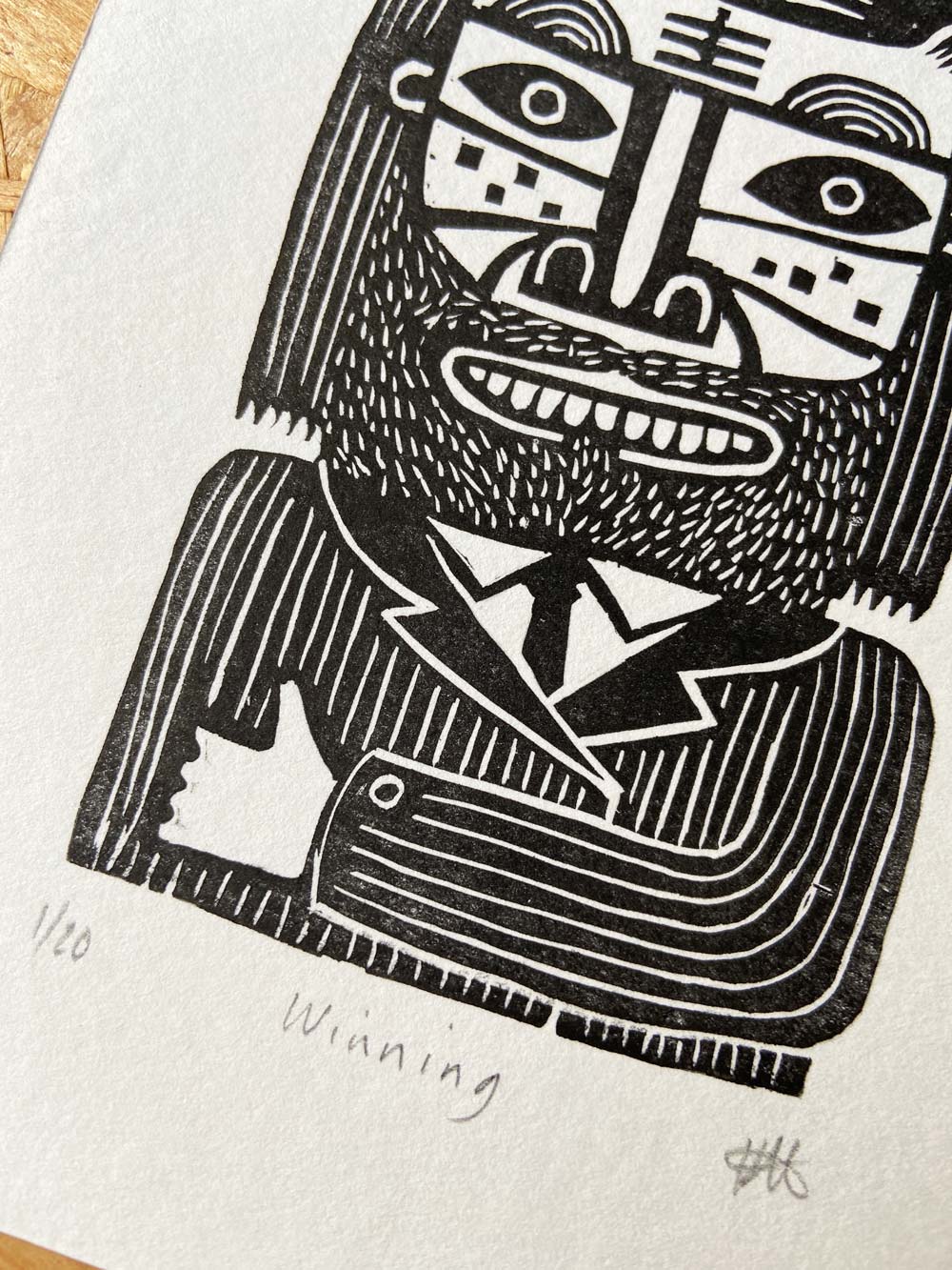 Black and white linocut image of a man cat wearing a pinstripe suit and holding up a thumb