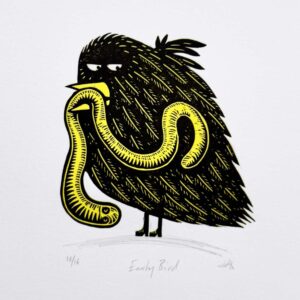 Early Bird handmade linocut print showing a black bird holding a yellow worm by Tigerlino