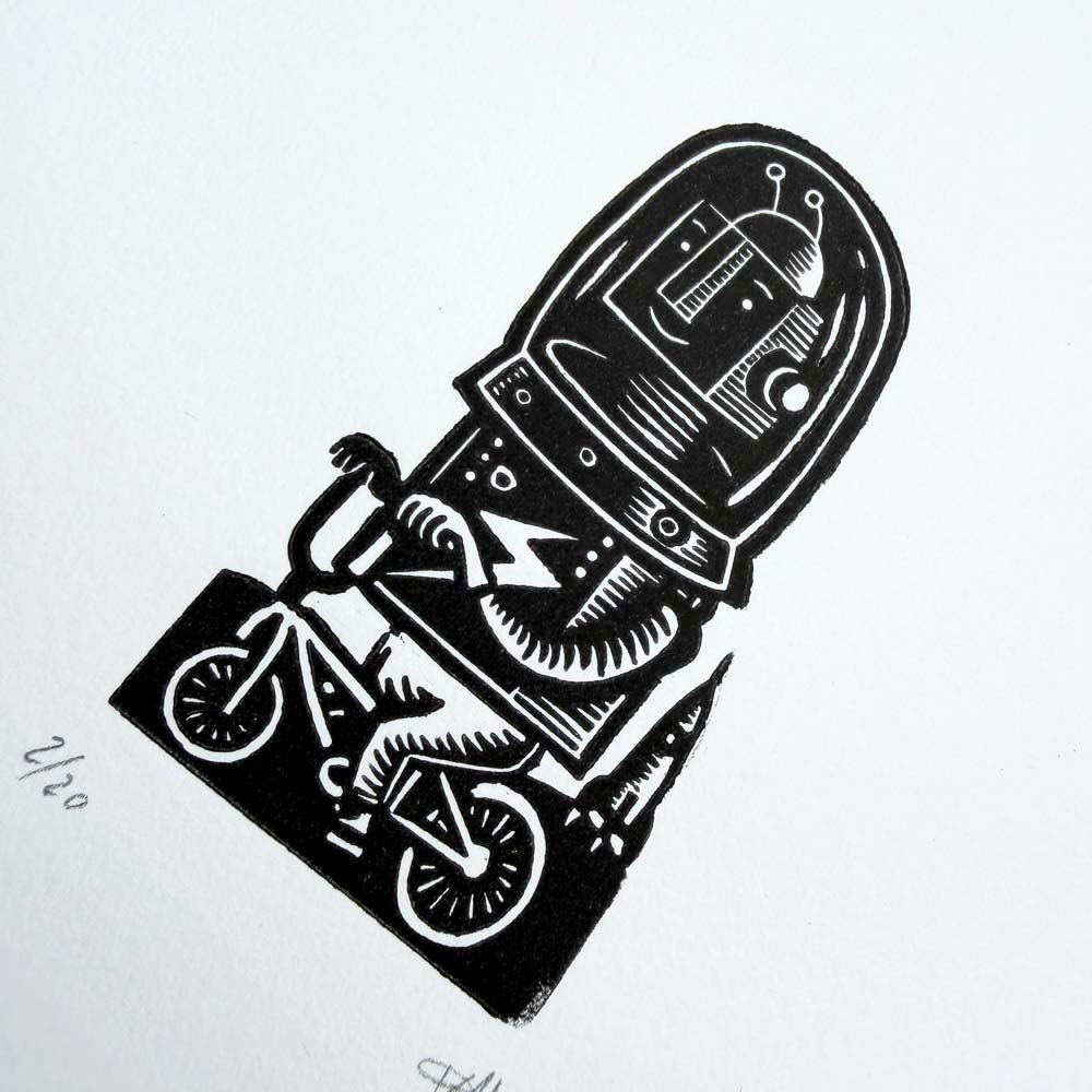 Cycling spaceman handmade linocut print featuring astronaut riding a bicycle by Tigerlino